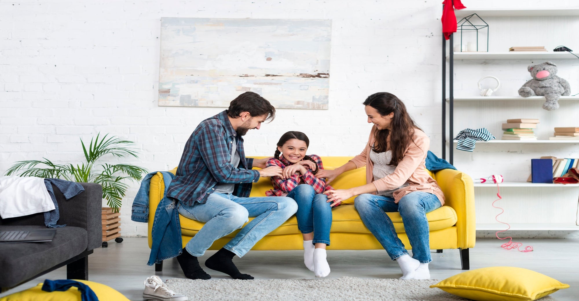 Family enjoy quality time on a yellow couch
